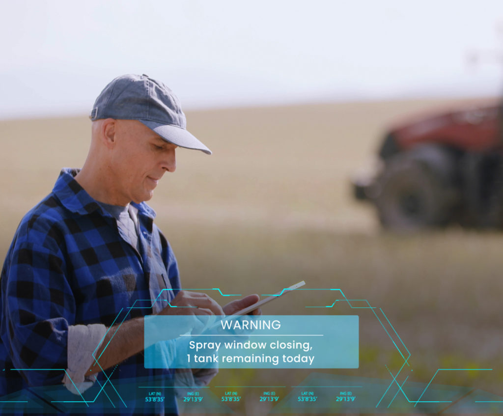 Farmer in a field with an ipad and a software notification superimposed over the top